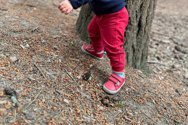 Red Ten Little Everyday Original shoes worn while walking on a forest slope