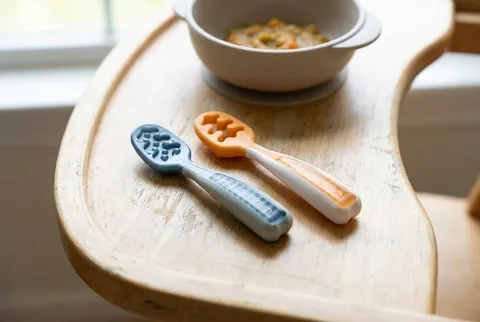 NumNum Pre-Spoon GOOtensils two-pack in blue and orange with textured silicone heads