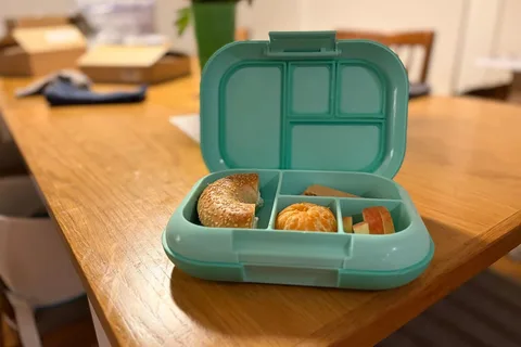 Our open aqua Bentgo Kids Chill lunch box packed with a bagel and fruit