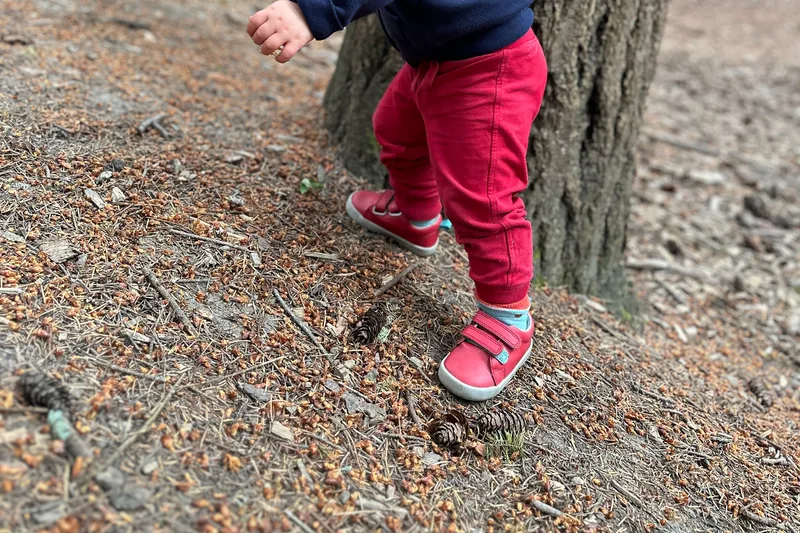 Red Ten Little Everyday Original shoes worn while walking on a forest slope