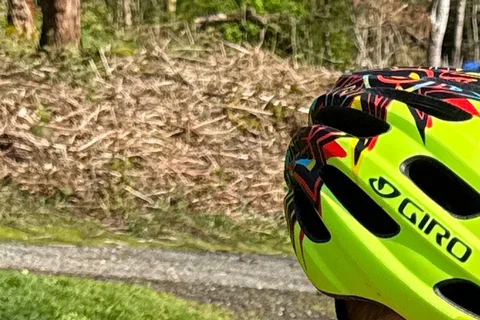 Close owner photo of the larger visored bright-green Giro Hale MIPS used by the older brother