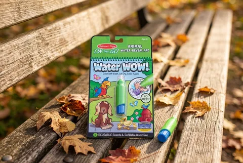 Melissa & Doug Water WOW! animal pad and water pen on a wooden bench with autumn leaves