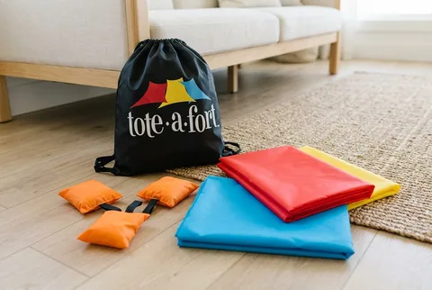 Tote-A-Fort Original Blanket Fort Kit clipped to furniture with blankets