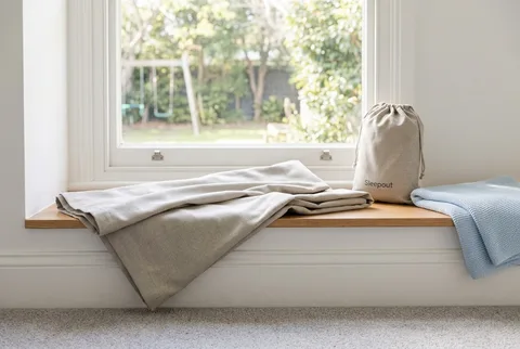 Sleepout Portable Blackout Curtain 3.0 shown mounted on a window with tension rods